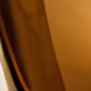Close crop of the perfume bottle side edge and amber glass texture · AI · 4x
