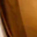 Close crop of the perfume bottle side edge and amber glass texture · Interpolation display