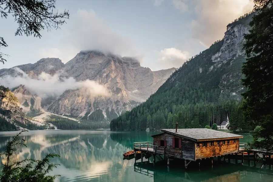 Alpine lake with a wooden boathouse on stilts